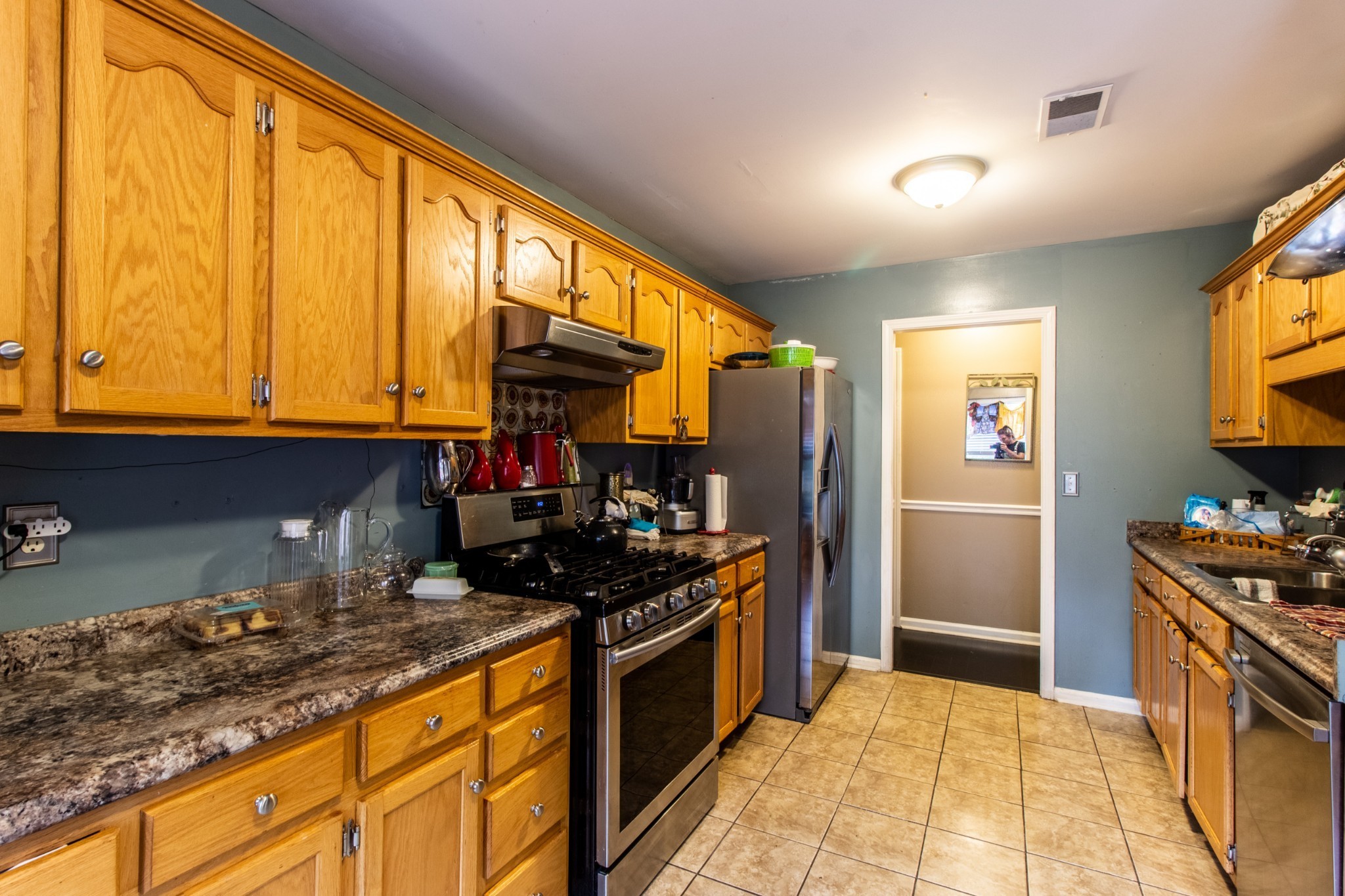 1371 Cowan Road Dickson, TN 37055 - Photo 6 of 18 a kitchen with stainless steel appliances granite countertop a stove a sink and a refrigerator