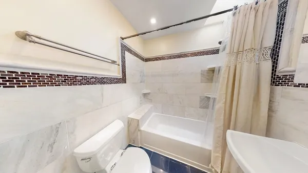 a bathroom with a toilet and a bathtub