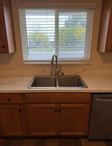 a kitchen with a sink and large window