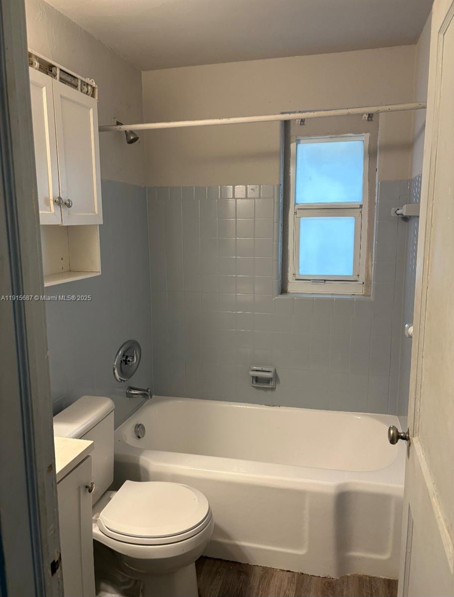 a bathroom with a toilet and a tub