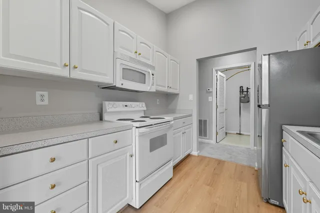 a kitchen with stainless steel appliances a sink stove and refrigerator