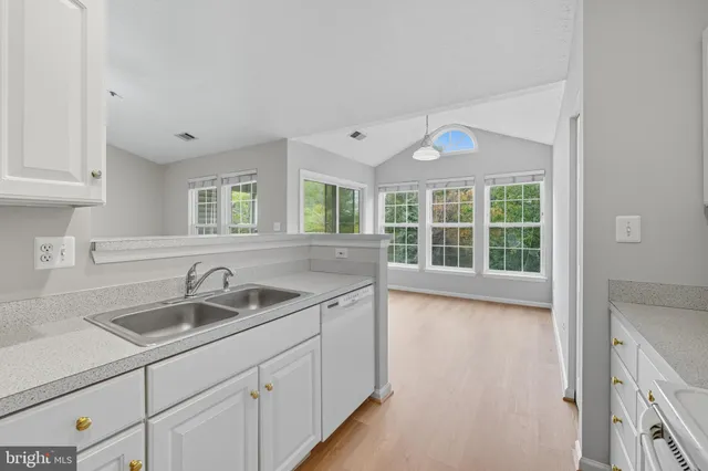 a kitchen with white cabinets and white appliances