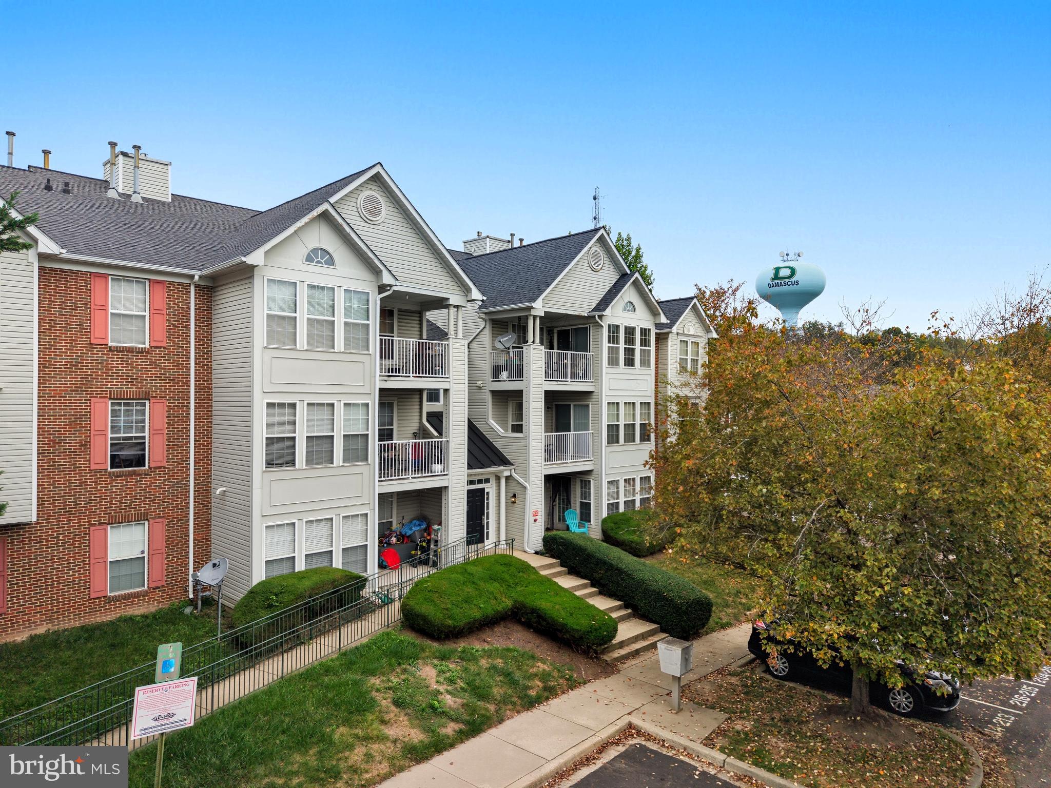 25910 Ridge Manor Drive, Unit 1000L Damascus, MD 20872 - Photo 3 of 51 Charming apartment complex with lush greenery.