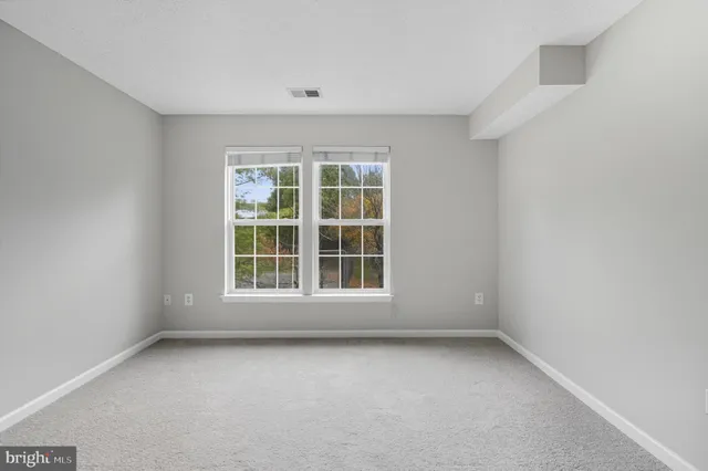 a bed room with a bed and a large window