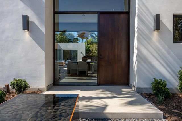 a living room with furniture kitchen view and a large window