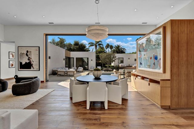 a kitchen with stainless steel appliances kitchen island a large counter space and wooden floor