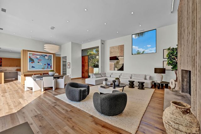a kitchen with stainless steel appliances kitchen island granite countertop a stove a sink and a chandelier