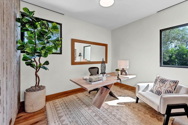 a bedroom with two beds and a large window