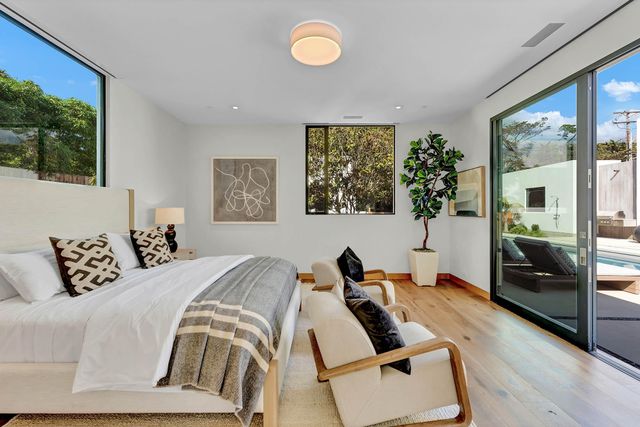 a view of swimming pool with lounge chair and couches