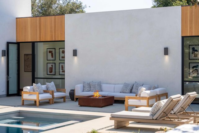 a kitchen with stainless steel appliances granite countertop a kitchen island a stove a table and chairs in it