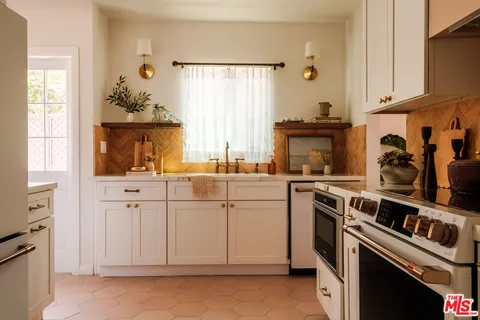 a kitchen with white cabinets and white appliances