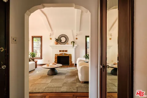a view of living room with furniture and a fireplace