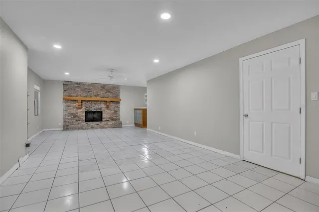 a view of empty room with fireplace and cabinet