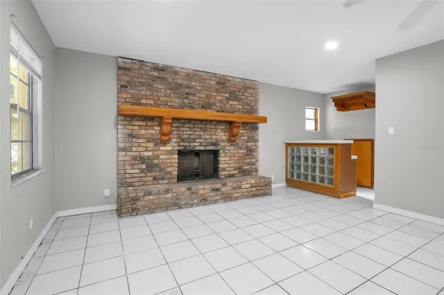 a view of an empty room with a fireplace