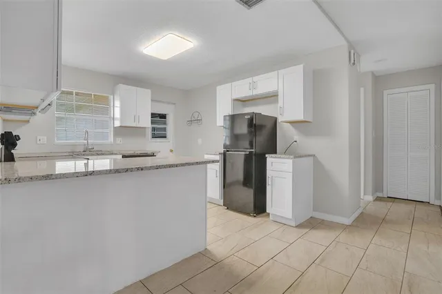 a kitchen with a refrigerator a stove and a sink
