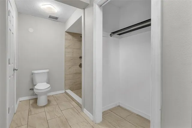 a bathroom with a toilet and a shower