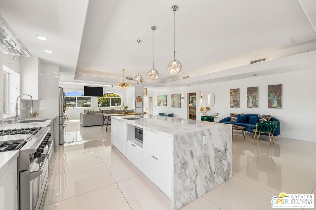 775 West Racquet Club Road Palm Springs, CA 92262 - Photo 11 of 38 a large white kitchen with lots of counter space and appliances