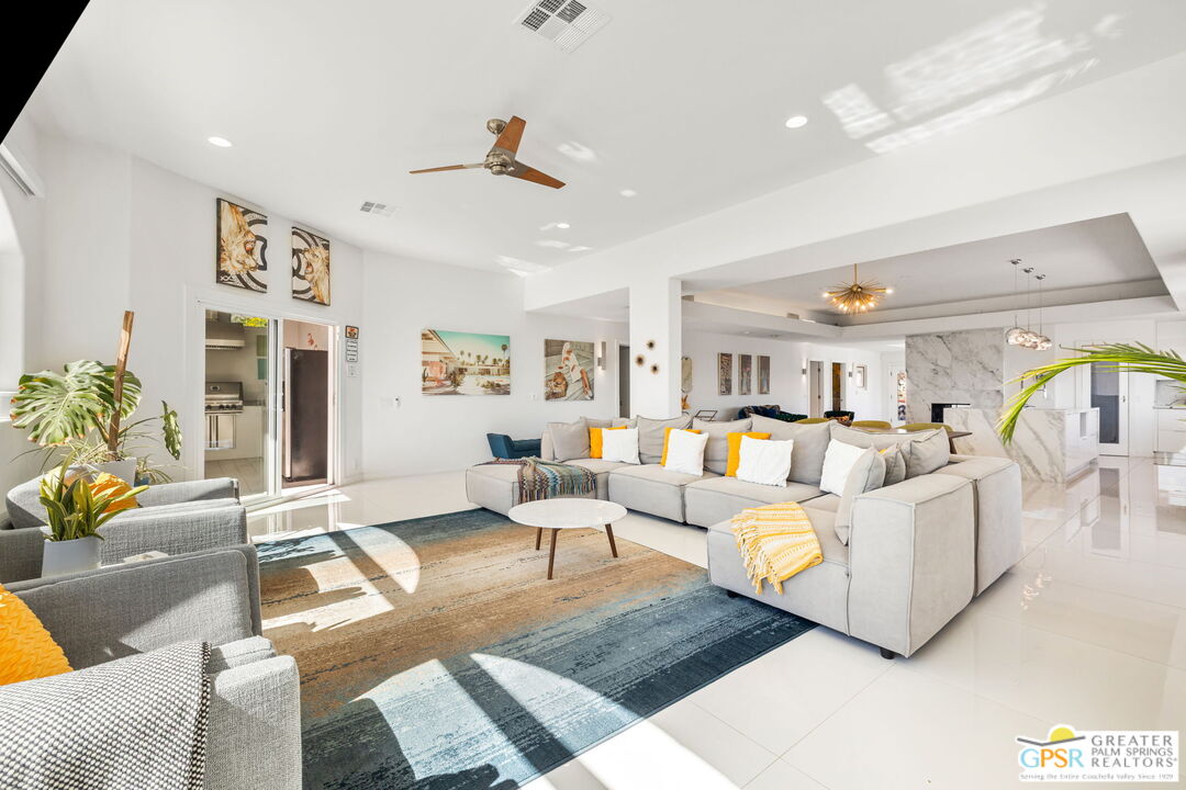 775 West Racquet Club Road Palm Springs, CA 92262 - Photo 16 of 38 a living room with furniture and a chandelier