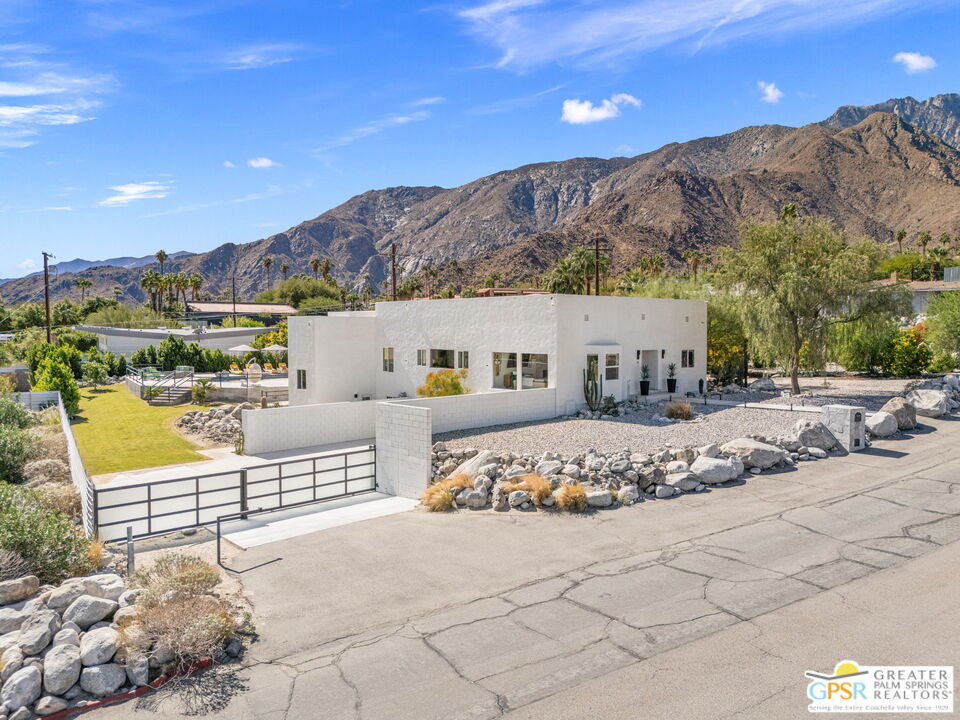 775 West Racquet Club Road Palm Springs, CA 92262 - Photo 2 of 38 a view of houses with a road