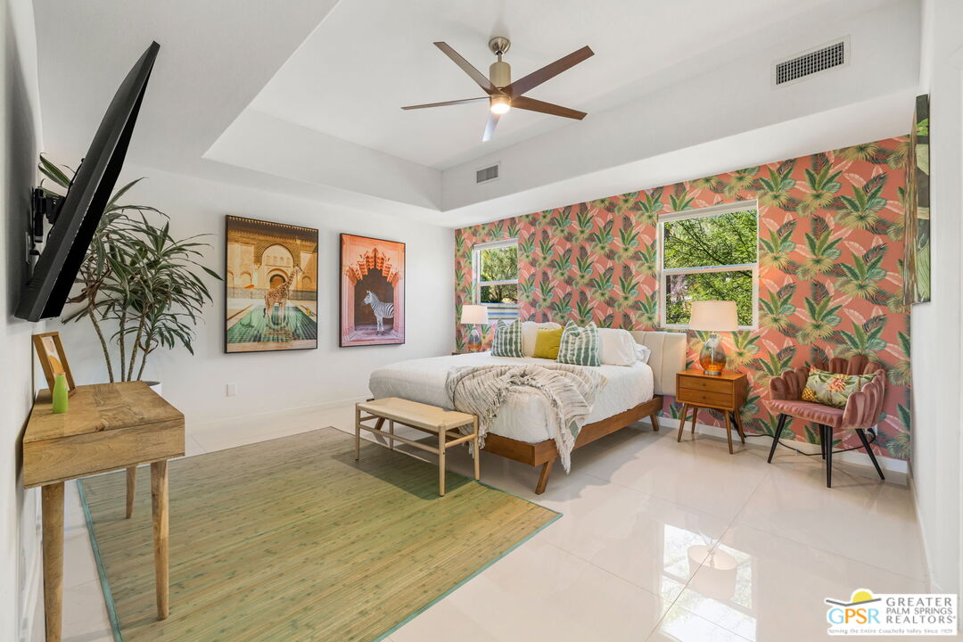 775 West Racquet Club Road Palm Springs, CA 92262 - Photo 21 of 38 a bedroom with a bed and a chandelier
