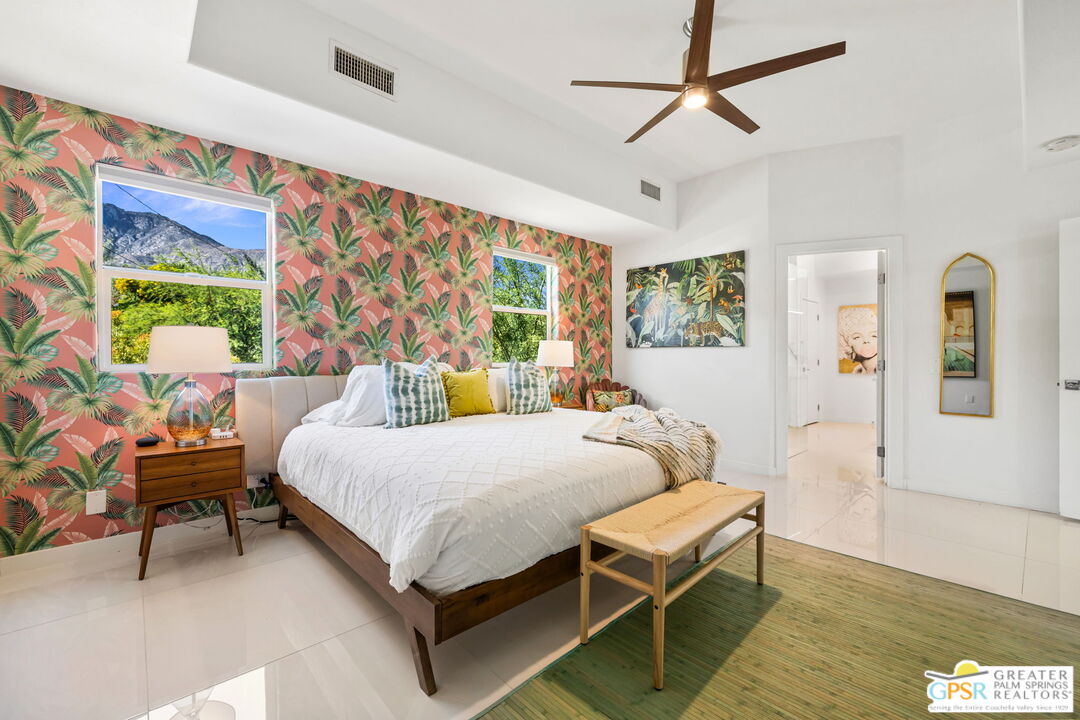 775 West Racquet Club Road Palm Springs, CA 92262 - Photo 22 of 38 a bedroom with a bed a couch and a window