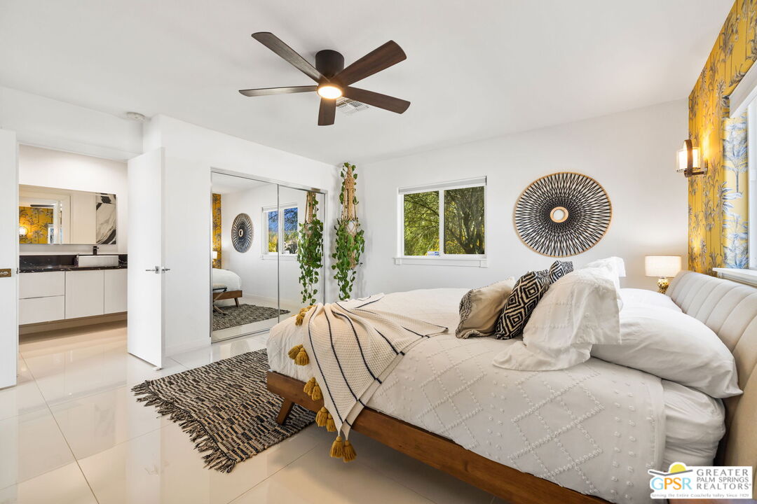 775 West Racquet Club Road Palm Springs, CA 92262 - Photo 26 of 38 a bedroom with a large bed and a chandelier