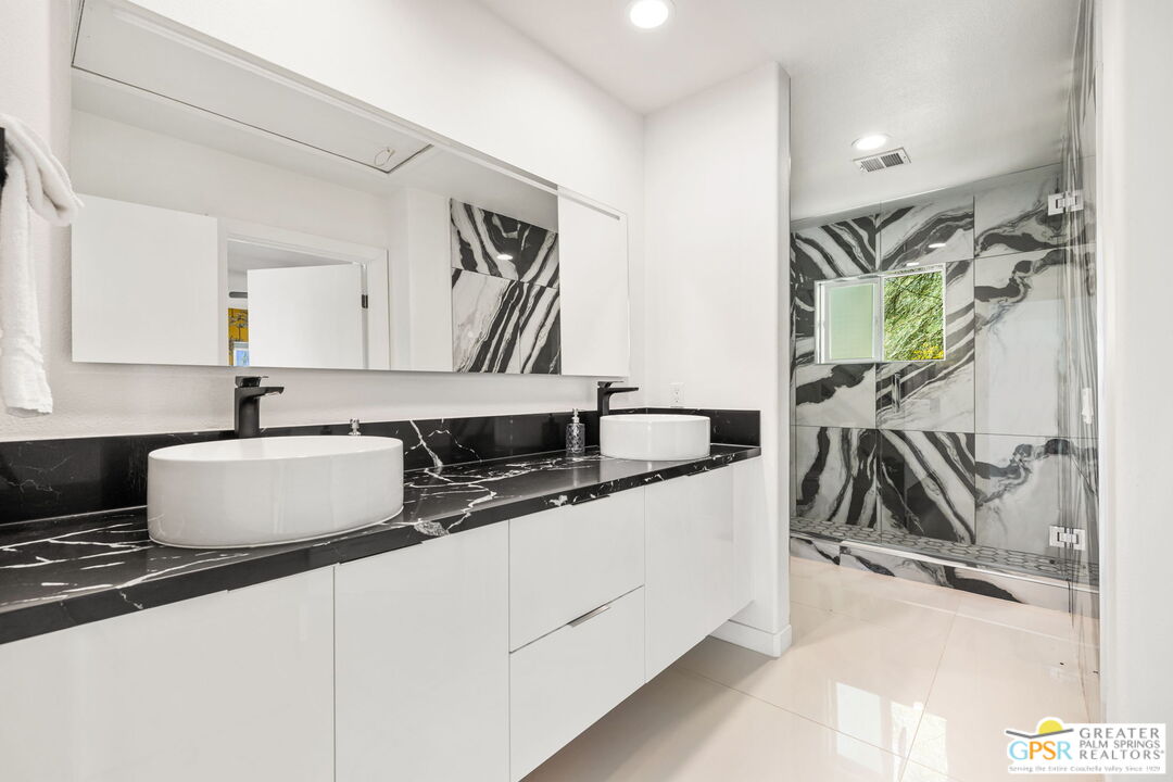 775 West Racquet Club Road Palm Springs, CA 92262 - Photo 27 of 38 a kitchen with stainless steel appliances a sink a stove and a refrigerator
