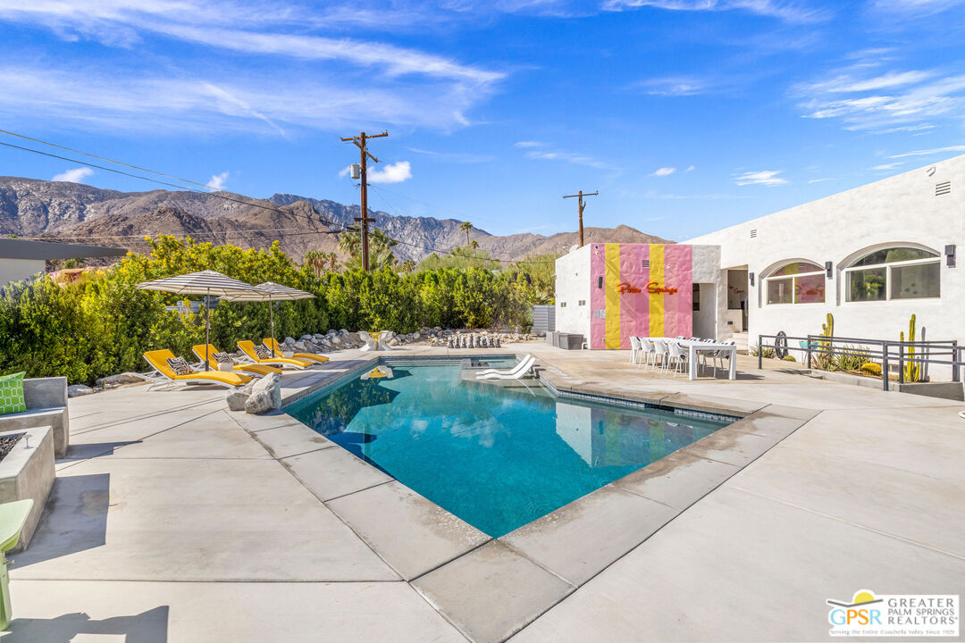 775 West Racquet Club Road Palm Springs, CA 92262 - Photo 28 of 38 a swimming pool with outdoor seating and yard