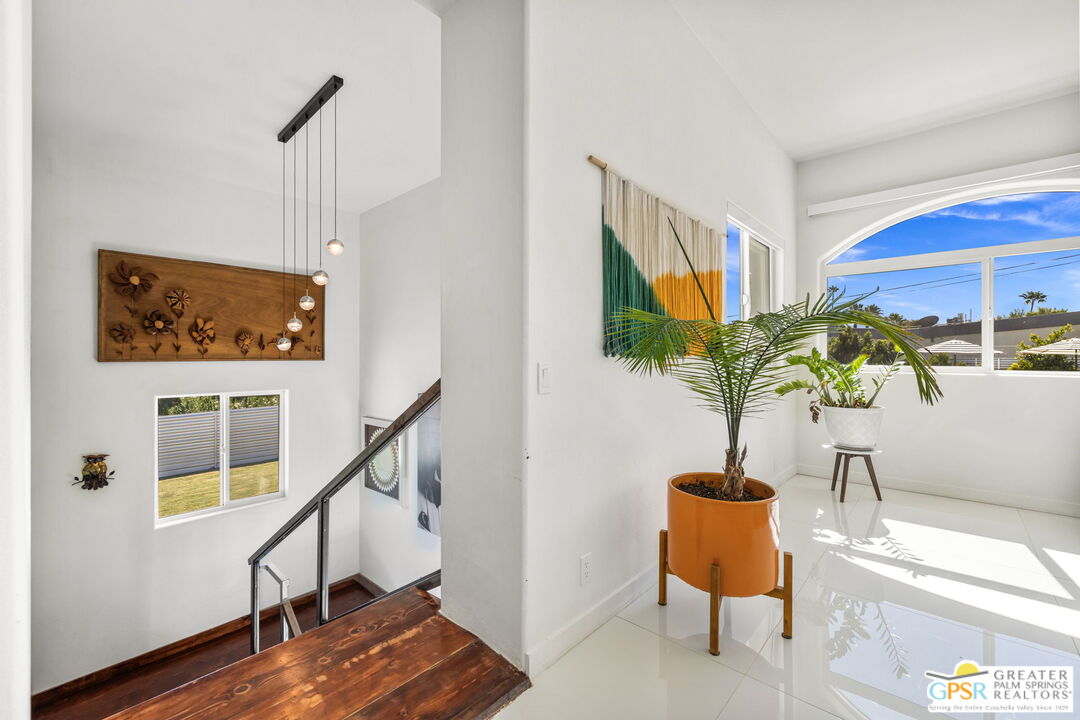 775 West Racquet Club Road Palm Springs, CA 92262 - Photo 30 of 38 a living room with furniture and a potted plant