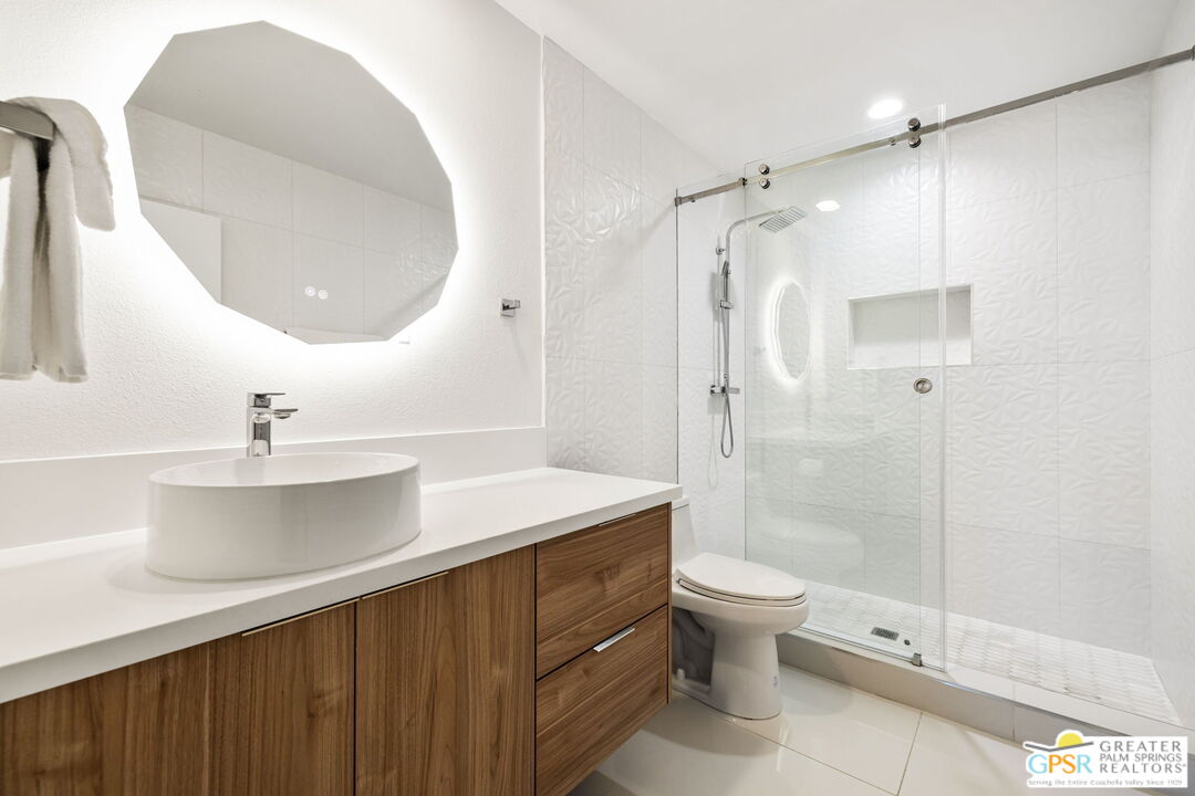 775 West Racquet Club Road Palm Springs, CA 92262 - Photo 33 of 38 a bathroom with a double vanity sink toilet mirror and shower