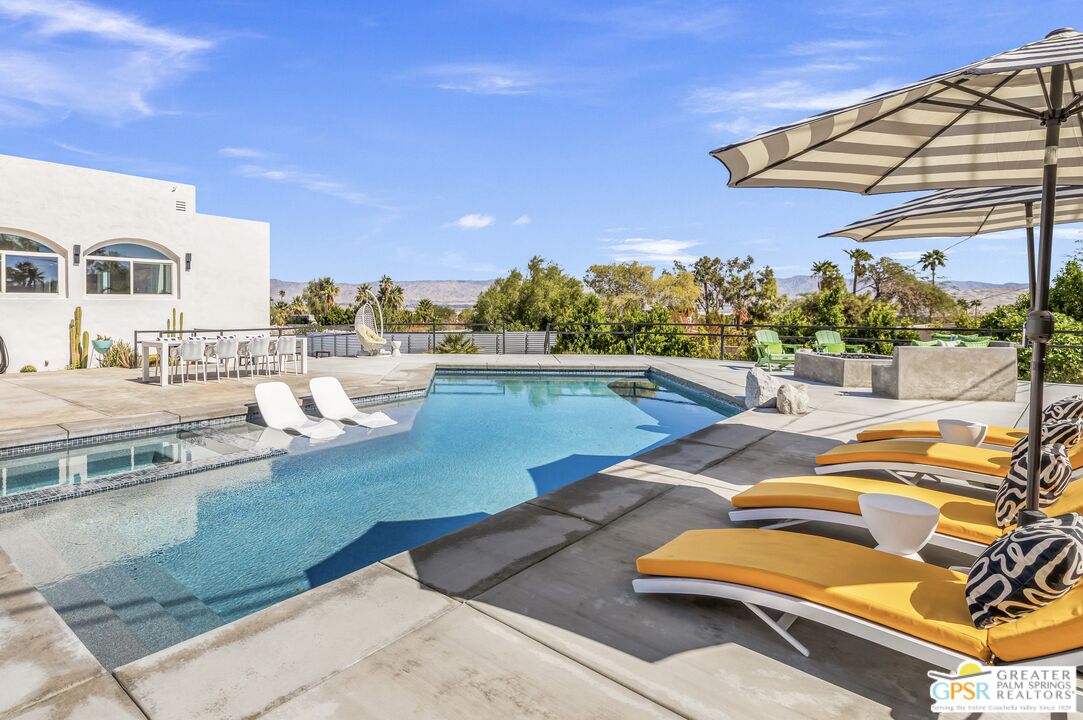 775 West Racquet Club Road Palm Springs, CA 92262 - Photo 6 of 38 a view of a swimming pool with lounge chairs