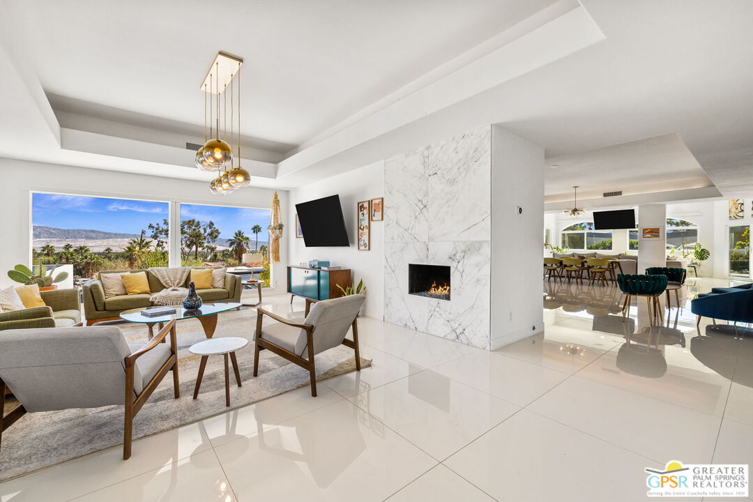 775 West Racquet Club Road Palm Springs, CA 92262 - Photo 9 of 38 a living room with furniture a flat screen tv and kitchen view