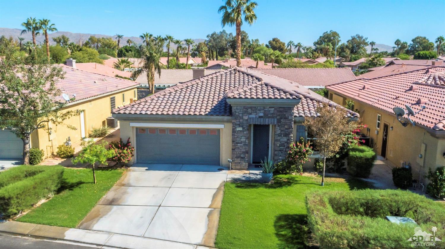 49568 Minelli Street Indio, CA 92201 - Photo 2 of 29 a front view of a house with a garden