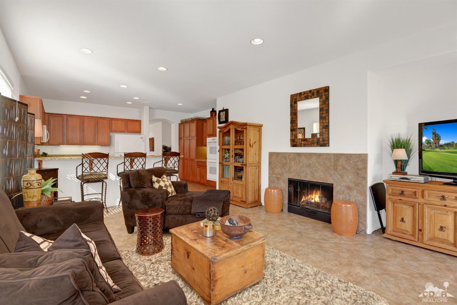 49568 Minelli Street Indio, CA 92201 - Photo 11 of 29 a living room with furniture and a fireplace