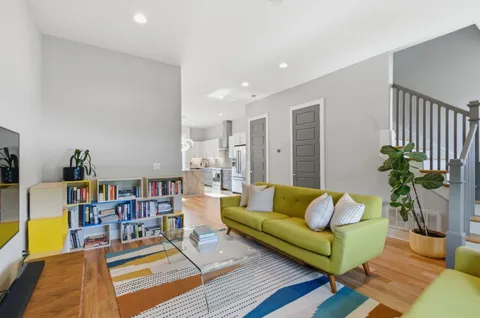a living room with furniture and a book shelf