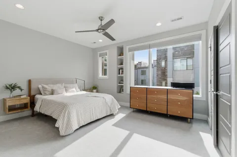 a spacious bedroom with a bed and a dresser