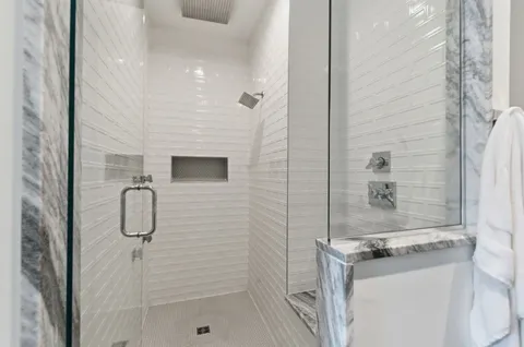 a bathroom with a granite countertop shower