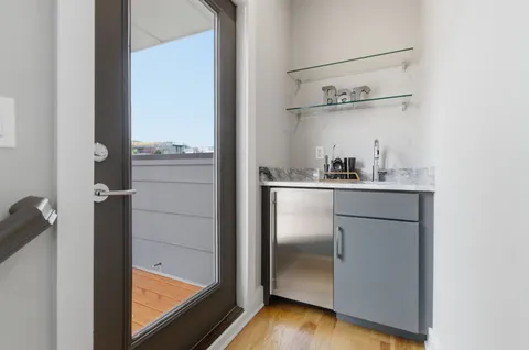 a kitchen with a refrigerator and a sink