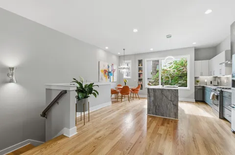 a living room with furniture windows and wooden floor