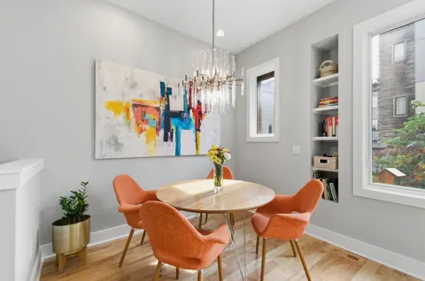 a view of a dining room with furniture and chandelier