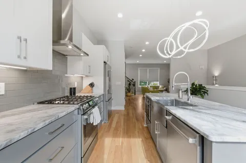 a kitchen with a stove and a white cabinets