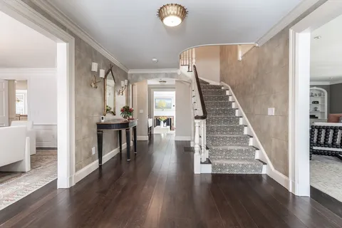 a view of entryway and hall with wooden floor