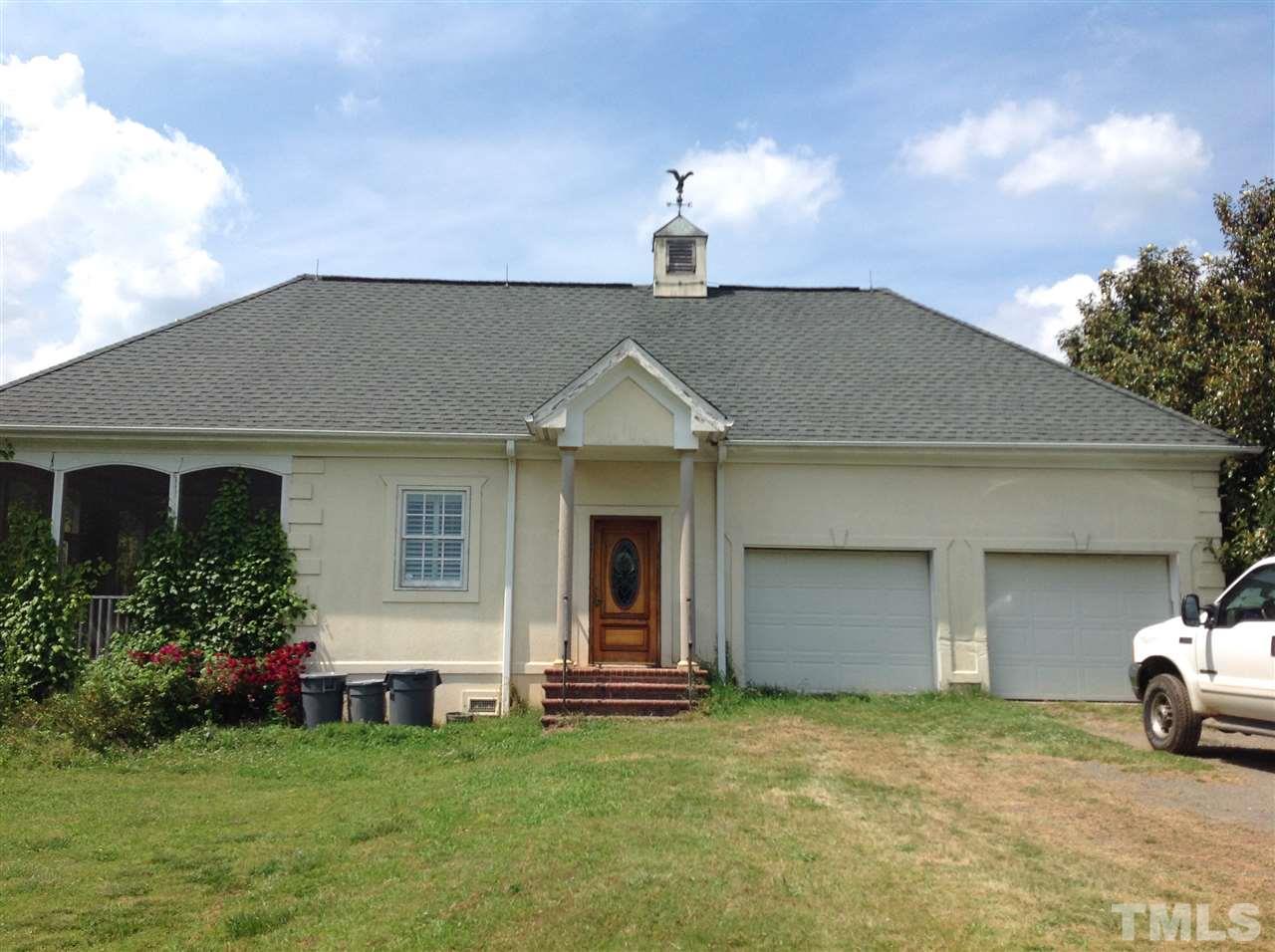 13333 Melvin Arnold Road Raleigh, NC 27613 - Photo 1 of 4 a front view of a house with a garden and yard