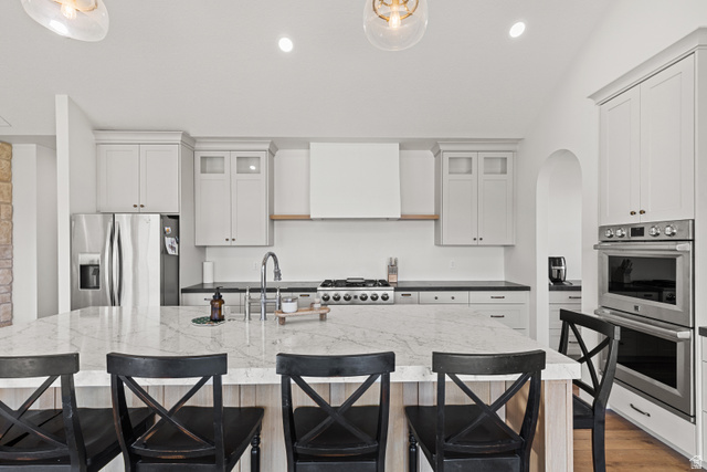 2920 West Temple Cyn Road Laketown, UT 84038 - Photo 15 of 69 White oak Island with "Accessible Beige" by SW surrounding cabinetry with ceiling height doors. Most lower cabinetry are drawer with so much storage.