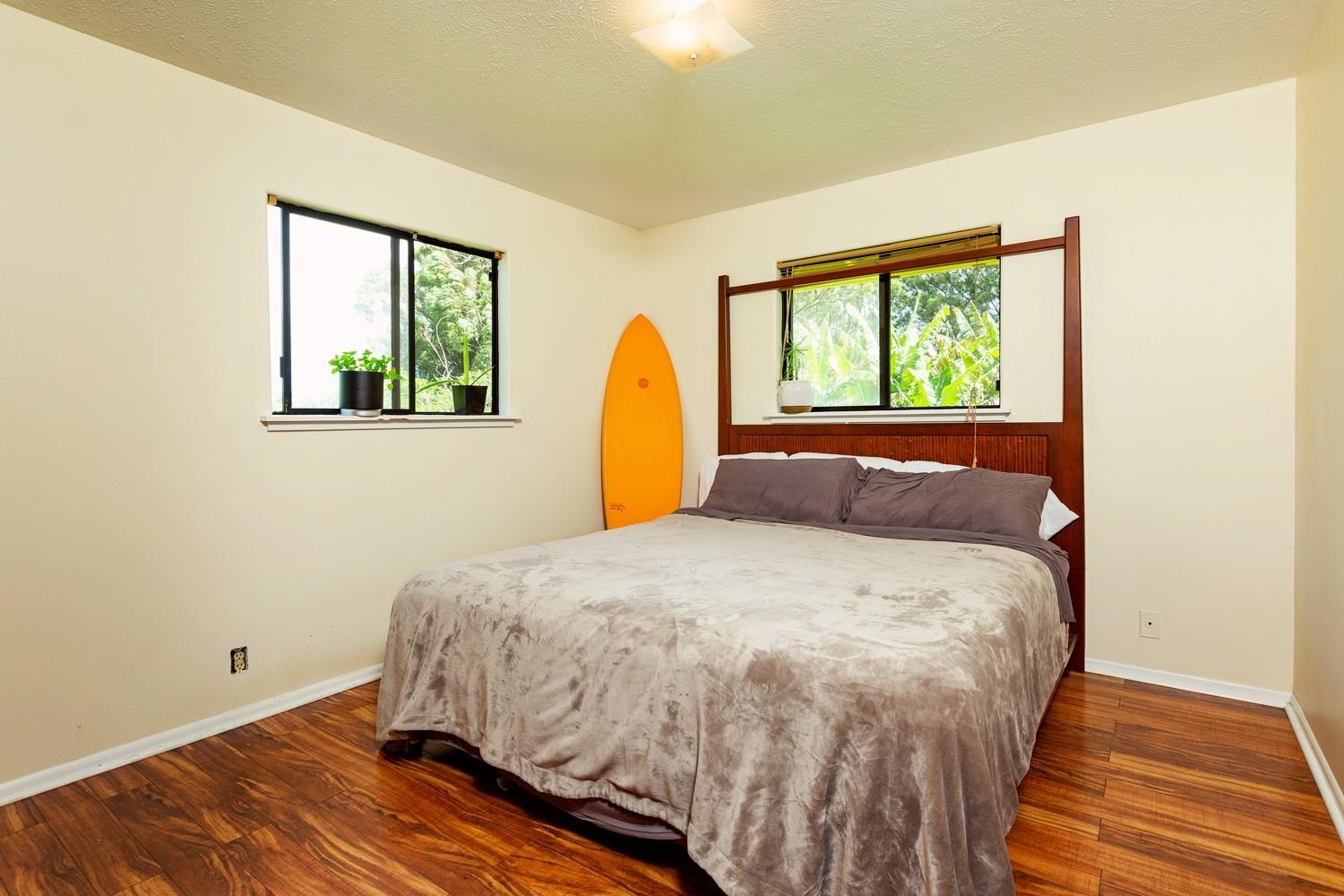 1034 Kaupakalua Road Haiku, HI 96708 - Photo 11 of 21 a bed sitting in a bedroom next to a window