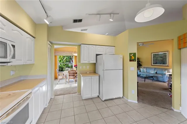 a kitchen with a refrigerator and a sink