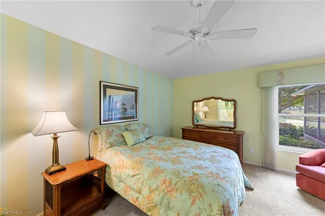 a bedroom with a bed and a lamp