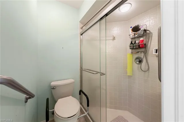 a bathroom with a toilet and a shower