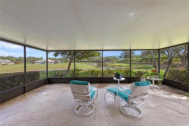 a living room with furniture and floor to ceiling window