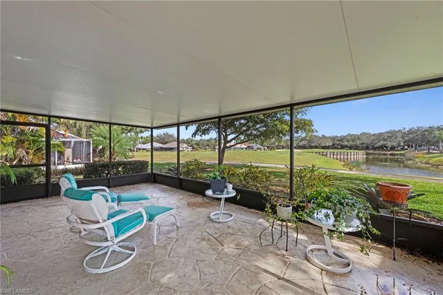a living room with a floor to ceiling window and pool table